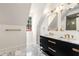 Elegant bathroom with marble countertops, black cabinets, and gold fixtures at 3582 Grove Gate Ln, Atlanta, GA 30339