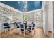 Elegant dining room with designer wallpaper, unique light fixture, and hardwood floors at 3582 Grove Gate Ln, Atlanta, GA 30339