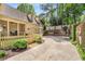 Long driveway leading to a two-car garage, enhanced by a manicured lawn and picket fence at 3582 Grove Gate Ln, Atlanta, GA 30339