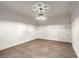 Empty room with wood floors, crown molding, and a modern light fixture at 3582 Grove Gate Ln, Atlanta, GA 30339