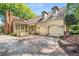 A two-car garage complements this house exterior, surrounded by professional landscaping at 3582 Grove Gate Ln, Atlanta, GA 30339