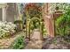 Lush garden path with an arched entrance and beautiful flowering plants at 3582 Grove Gate Ln, Atlanta, GA 30339