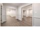 Hallway featuring wood floors, detailed trim, and multiple doorways at 3582 Grove Gate Ln, Atlanta, GA 30339