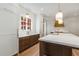 Bright kitchen features a large island with a sink, custom cabinets and a view of the fall foliage at 3582 Grove Gate Ln, Atlanta, GA 30339