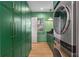 Modern laundry room with green cabinets, modern machines and lots of storage at 3582 Grove Gate Ln, Atlanta, GA 30339