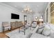 Open concept living room with modern furnishings and an adjacent kitchen at 3582 Grove Gate Ln, Atlanta, GA 30339
