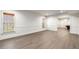 Bright living room with wood floors, wainscoting, and a view to the game room at 3582 Grove Gate Ln, Atlanta, GA 30339