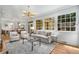 Bright living room with large windows, modern lighting, and neutral decor at 3582 Grove Gate Ln, Atlanta, GA 30339