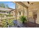 Covered outdoor porch with seating area overlooking landscaped backyard at 3582 Grove Gate Ln, Atlanta, GA 30339