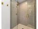 Modern shower with glass door features gray subway tile and gold fixtures at 3582 Grove Gate Ln, Atlanta, GA 30339
