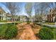 Scenic neighborhood view with a brick pathway, benches and neatly landscaped common areas at 3582 Grove Gate Ln, Atlanta, GA 30339