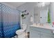 Modern bathroom with gray cabinets, white sink, and stylish blue patterned shower curtain, creating a sleek and functional space at 85 Ann Se Cir, Cartersville, GA 30121