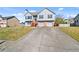 Two-story home with gray siding, brick accents, and two-car garage at 85 Ann Se Cir, Cartersville, GA 30121