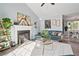 Cozy living room with a fireplace, comfortable sofa, and an open view to the dining and kitchen areas at 85 Ann Se Cir, Cartersville, GA 30121