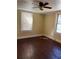 Comfortable bedroom showcasing gleaming hardwood floors, bright windows, and a ceiling fan at 1415 Dodson Sw Dr, Atlanta, GA 30311