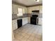 Functional kitchen area equipped with white cabinets and modern black appliances for easy meal prep at 1415 Dodson Sw Dr, Atlanta, GA 30311