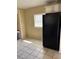 Kitchen featuring black refrigerator, white cabinetry, and a window at 1415 Dodson Sw Dr, Atlanta, GA 30311