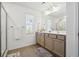 Bright bathroom features double vanity with updated fixtures and a large mirror at 1484 Ben Park Way, Grayson, GA 30017