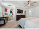 Comfortable bedroom with a ceiling fan, large TV, and crib at 1484 Ben Park Way, Grayson, GA 30017