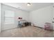 Bright bedroom with large window, neutral carpet, and changing table at 1484 Ben Park Way, Grayson, GA 30017
