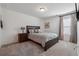 Cozy bedroom featuring a comfortable bed, bedside table and lamp, and gray carpet at 1484 Ben Park Way, Grayson, GA 30017