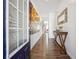 Inviting entryway with wood floors, decorative console table, and colorful artwork at 1484 Ben Park Way, Grayson, GA 30017