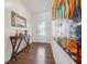 Hallway with wood-look floors, console table with decorations and decorative mirror at 1484 Ben Park Way, Grayson, GA 30017