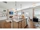 Open-concept kitchen features granite counters, stainless steel appliances, and views to living room at 1484 Ben Park Way, Grayson, GA 30017