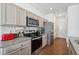 Modern kitchen with stainless steel appliances, granite counters, and ample cabinet storage at 1484 Ben Park Way, Grayson, GA 30017