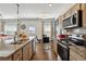 Well-equipped kitchen with stainless steel appliances, granite counters, and eat-in dining area at 1484 Ben Park Way, Grayson, GA 30017