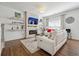 Cozy living room with modern fireplace, floating shelves, comfortable seating, and wood-look floors at 1484 Ben Park Way, Grayson, GA 30017