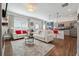 Open-concept living area with white sofas, modern decor, and seamless flow to the kitchen at 1484 Ben Park Way, Grayson, GA 30017