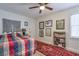Cozy bedroom with ceiling fan, eclectic decor, and a colorful patterned bedspread at 160 Vine Nw St, Atlanta, GA 30314