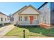 Charming home featuring a quaint front porch, a well-maintained lawn, and an orange front door at 160 Vine Nw St, Atlanta, GA 30314