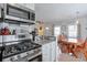 Open kitchen with stainless steel appliances and a view into the dining area at 160 Vine Nw St, Atlanta, GA 30314