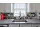 Modern kitchen sink with granite countertop, stylish backsplash, and bright natural light at 160 Vine Nw St, Atlanta, GA 30314