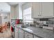 Bright kitchen features a stainless steel sink, granite countertops, and stylish backsplash at 160 Vine Nw St, Atlanta, GA 30314