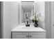 Bathroom vanity features a decorative mirror and flower arrangement at 2735 Varlet Ct, Snellville, GA 30039