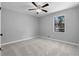 Simple bedroom with new carpet, neutral paint, a ceiling fan and a window at 2735 Varlet Ct, Snellville, GA 30039
