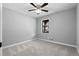 This bedroom features neutral walls, modern fan fixture and plush carpet at 2735 Varlet Ct, Snellville, GA 30039