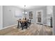 Modern dining room featuring hardwood floors, stylish light fixture and backyard view at 2735 Varlet Ct, Snellville, GA 30039