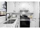 Updated kitchen with a stainless steel sink, granite counters, and a stainless steel gas range at 2735 Varlet Ct, Snellville, GA 30039