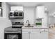 Modern kitchenette boasts stainless steel appliances, bright countertops, and ample storage at 2735 Varlet Ct, Snellville, GA 30039