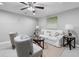 This living room includes a decorative fan, soft lighting and neutral gray decor at 2735 Varlet Ct, Snellville, GA 30039