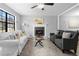 Sun-filled living room boasts a cozy fireplace and comfortable seating arrangements at 2735 Varlet Ct, Snellville, GA 30039