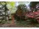 Exterior of brick home with a wooden deck surrounded by lush landscaping at 3117 Kings Arms Ne Ct, Atlanta, GA 30345