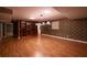 Spacious finished basement with wood floors, stylish lighting, and built-in shelving at 3117 Kings Arms Ne Ct, Atlanta, GA 30345