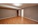 Basement living space includes neutral paint, wood floors, base trim and access to the stairs at 3117 Kings Arms Ne Ct, Atlanta, GA 30345