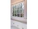Bathroom with a jacuzzi tub, a window with a wooded view, and tiled trim at 3117 Kings Arms Ne Ct, Atlanta, GA 30345