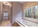 Bathroom featuring a jacuzzi tub with a view to the outside at 3117 Kings Arms Ne Ct, Atlanta, GA 30345